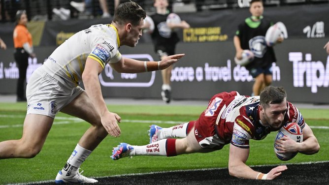 Warrington (pictured conceding a try to Wigan) face Willie Peters' Hull KR in the Challenge Cup.  (AP PHOTO)