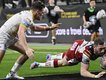Warrington (pictured conceding a try to Wigan) face Willie Peters' Hull KR in the Challenge Cup.  (AP PHOTO)